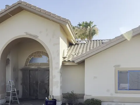 Before — Arched entry of Fountain Hills AZ home during prep with masking and after finished exterior repaint